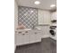Well-organized laundry room with modern washer and dryer, custom cabinets, and decorative tile flooring at 1126 Ocean Forest Lane, 1/8 Share, Seabrook Island, SC 29455