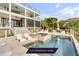 Luxury home featuring a private pool with sun loungers and lush landscaping, perfect for outdoor relaxation and entertaining at 1126 Ocean Forest Lane, 1/8 Share, Seabrook Island, SC 29455