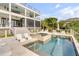 Exterior pool area with a spa and sun loungers, next to a screened porch and stairs to a multi-level home at 1126 Ocean Forest Lane, 1/8 Share, Seabrook Island, SC 29455