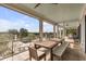Spacious screened-in porch with dining table and bench seating overlooking the pool and beautiful landscape at 1126 Ocean Forest Lane, 1/8 Share, Seabrook Island, SC 29455