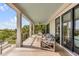 Covered porch with outdoor seating, ceiling fan, and stunning views of the surrounding landscape at 1126 Ocean Forest Lane, 1/8 Share, Seabrook Island, SC 29455