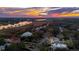 Sunset aerial view of homes along a riverfront with boat docks and lush greenery at 12 Broughton Rd, Charleston, SC 29407