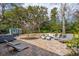 Backyard patio with lounge chairs, outdoor seating, and a shed surrounded by lush landscaping at 12 Broughton Rd, Charleston, SC 29407