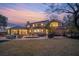 Backyard with a patio, hot tub, outdoor seating, and a well-maintained lawn at sunset at 12 Broughton Rd, Charleston, SC 29407