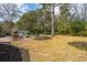 Backyard features patio area, a fire pit, and a storage shed surrounded by well-maintained lawn at 12 Broughton Rd, Charleston, SC 29407