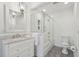 Bright bathroom with marble counters, glass shower doors, and tiled floor at 12 Broughton Rd, Charleston, SC 29407