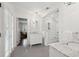 Bright bathroom with marble counters, glass shower doors, and tiled floor at 12 Broughton Rd, Charleston, SC 29407