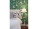 Up close, this bedroom features floral wallpaper, a nightstand, and decorative lamps at 12 Broughton Rd, Charleston, SC 29407