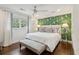 Charming bedroom features hardwood floors, a ceiling fan, and a stylish accent wall at 12 Broughton Rd, Charleston, SC 29407