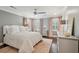 Bright bedroom with hardwood floors, a ceiling fan, and neutral colored walls at 12 Broughton Rd, Charleston, SC 29407