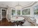 Charming breakfast nook featuring a round table, comfortable seating, a crystal chandelier, and large windows at 12 Broughton Rd, Charleston, SC 29407