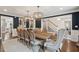 Formal dining room boasts hardwood flooring, large table, designer lighting, and artwork at 12 Broughton Rd, Charleston, SC 29407