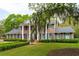 Elegant brick house with mature trees and Spanish moss enhancing its curb appeal at 12 Broughton Rd, Charleston, SC 29407