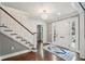 Elegant foyer with hardwood floors, decorative rug, and staircase to the second floor at 12 Broughton Rd, Charleston, SC 29407