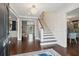 Bright foyer featuring hardwood floors, a staircase, a chandelier, and elegant trim at 12 Broughton Rd, Charleston, SC 29407