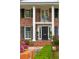 Elegant doorway with classic white columns, black door and stylish sidelights and hardware at 12 Broughton Rd, Charleston, SC 29407