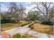 Stunning traditional-style home with sprawling lawn, brick pathway, and mature trees at 12 Broughton Rd, Charleston, SC 29407