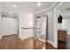 Bright hallway with hardwood floors, wide staircase, and large decorative mirror at 12 Broughton Rd, Charleston, SC 29407