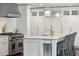 Bright kitchen with a spacious island, modern appliances, white cabinets, and elegant pendant lighting at 12 Broughton Rd, Charleston, SC 29407