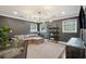 Comfortable living room boasts modern lighting fixture, gray walls, and a large sectional sofa for relaxation at 12 Broughton Rd, Charleston, SC 29407