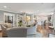 Open-concept living room leading to a kitchen with white cabinets and a center island at 12 Broughton Rd, Charleston, SC 29407