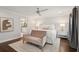 Bright main bedroom featuring neutral decor, a seating area, and an en-suite bathroom at 12 Broughton Rd, Charleston, SC 29407