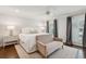 Serene main bedroom with a plush bed, seating area, and windows with natural light at 12 Broughton Rd, Charleston, SC 29407