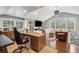 Spacious office features a vaulted ceiling, hardwood floors, a large desk, and cozy seating areas at 12 Broughton Rd, Charleston, SC 29407