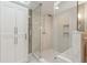 Modern walk-in shower with glass enclosure, marble-like tile, and rainfall showerhead at 12 Broughton Rd, Charleston, SC 29407