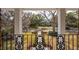 An ornate wrought-iron balcony provides an idyllic view of the main house at 12 Broughton Rd, Charleston, SC 29407