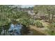 Aerial shot of home with private waterfront access, a well-kept lawn and lush landscaping at 1208 Wynnwood Ct, Mount Pleasant, SC 29464