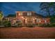 A spacious back exterior featuring a brick home with a manicured yard and outdoor seating area at 1208 Wynnwood Ct, Mount Pleasant, SC 29464