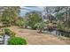 Serene backyard featuring mature trees and direct waterfront access at 1208 Wynnwood Ct, Mount Pleasant, SC 29464