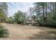 Spacious backyard featuring lush greenery, serene pond views, and mature trees creating a private oasis at 1208 Wynnwood Ct, Mount Pleasant, SC 29464