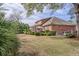 Expansive backyard with lush landscaping, patio with seating, and a well-maintained lawn at 1208 Wynnwood Ct, Mount Pleasant, SC 29464