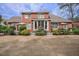 Backyard with an outdoor seating area with an umbrella and lush landscaping at 1208 Wynnwood Ct, Mount Pleasant, SC 29464