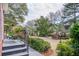Scenic backyard with mature trees, landscape lighting, lush greenery, and tranquil water view at 1208 Wynnwood Ct, Mount Pleasant, SC 29464