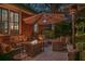 Relaxing backyard patio featuring comfortable seating, a fire pit, and outdoor heater and ambient lighting at 1208 Wynnwood Ct, Mount Pleasant, SC 29464