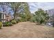 Expansive backyard with a patio, waterfront view, mature trees, and well-maintained lawn at 1208 Wynnwood Ct, Mount Pleasant, SC 29464
