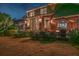 An inviting backyard showcases a brick home, patio, and outdoor seating with fire pit under an umbrella at 1208 Wynnwood Ct, Mount Pleasant, SC 29464