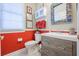 Charming bathroom with stylish red paneled walls, vanity with storage, and decorative mirror at 1208 Wynnwood Ct, Mount Pleasant, SC 29464