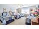 Light-filled bedroom with three twin beds, blue baseball-themed bedding, and neutral carpet at 1208 Wynnwood Ct, Mount Pleasant, SC 29464