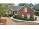 Charming brick home featuring a well-manicured lawn, mature trees, and inviting curb appeal at 1208 Wynnwood Ct, Mount Pleasant, SC 29464