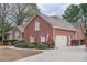 Beautiful brick home with a two-car garage, American flag, and well-maintained landscaping at 1208 Wynnwood Ct, Mount Pleasant, SC 29464