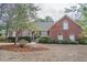 Charming brick home with lush landscaping, well-manicured lawn, and a welcoming front entrance at 1208 Wynnwood Ct, Mount Pleasant, SC 29464