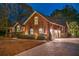 Stately brick home with attached garage, flag display, and manicured shrubs lining the driveway at 1208 Wynnwood Ct, Mount Pleasant, SC 29464