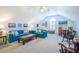 Bright living room with blue couches, a ceiling fan, several decorations, and a beige carpet at 1208 Wynnwood Ct, Mount Pleasant, SC 29464