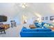 Bright living room features vaulted ceilings, neutral carpet, and comfortable blue furniture with stylish decor at 1208 Wynnwood Ct, Mount Pleasant, SC 29464