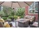 Cozy patio with lounge chairs, an umbrella, a heater, and lush backyard with mature trees at 1208 Wynnwood Ct, Mount Pleasant, SC 29464