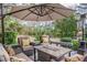 Inviting patio with comfortable lounge furniture, umbrella, and pond views for relaxing outdoor living at 1208 Wynnwood Ct, Mount Pleasant, SC 29464